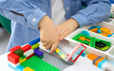 Robotics programming class. Children construct and code Robot. STEM education using constructor blocks and laptop, remote control joystick. Technology educational development for school kids. Advertisement copy spaceの写真素材