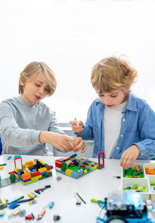 Robotics programming class. Children construct and code Robot. STEM education using constructor blocks and laptop, remote control joystick. Technology educational development for school kids. Advertisement copy spaceの写真素材