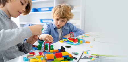 Robotics programming class. Children construct and code Robot. STEM education using constructor blocks and laptop, remote control joystick. Technology educational development for school kids. Advertisement copy spaceの写真素材
