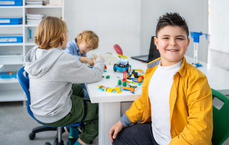 Robotics programming class. Children construct and code Robot. STEM education using constructor blocks and laptop, remote control joystick. Technology educational development for school kids. Advertisement copy spaceの写真素材