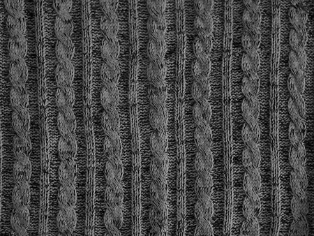 Gray knitted pattern background, part of beautiful sweater. Hobbies. Knitted ornament. Copy spaceの写真素材