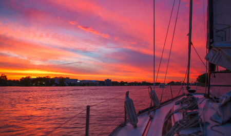 Amazing sunset view from the boat on the Parana river in Argentina. Beautiful colors of sky and water. Sailing ship tourism. の写真素材