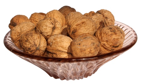 Walnuts in a plate isolated on white background