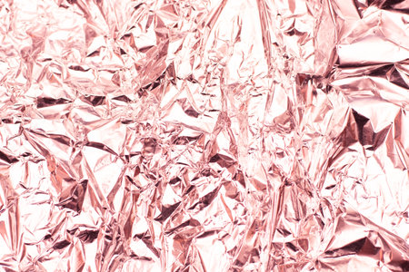 Crumpled aluminum foil texture background in pink tone. Abstract background and texture for design.の写真素材