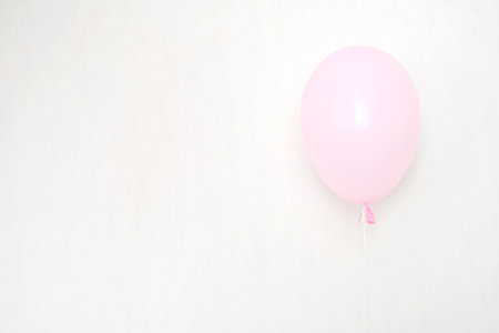 A bundle of pink and transparent air balloons with silver confetti, copy space for your text, tender pastel colors for a girlish partyの写真素材