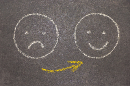 Drawing of a smiling face and a madの写真素材