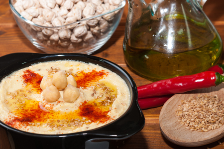 Plate of hummus and various ingredientsの写真素材