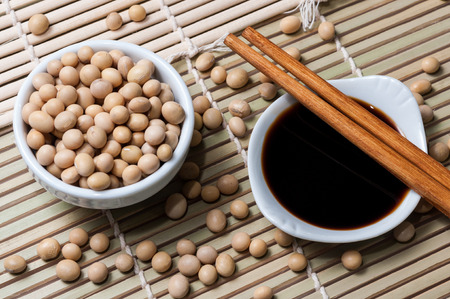 A bowl with soy sauce and One with soybeansの写真素材