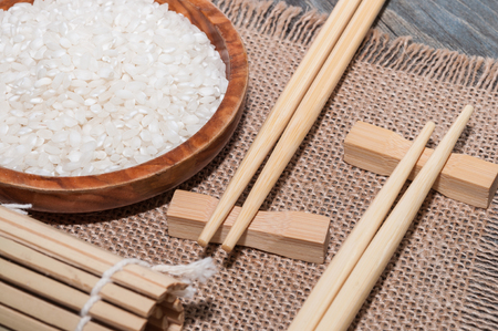 White rice, a tablecloth and one chopsticksの写真素材