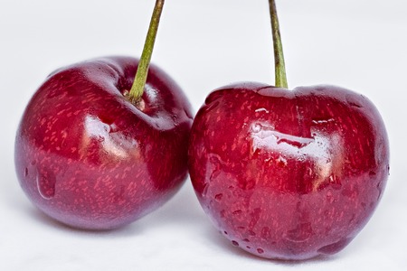 macro photography of cherries on white background