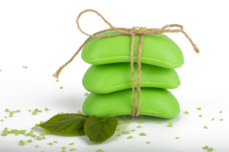 Green soap, tied with twine, bath salt. Sprig with leaves. On white, isolated background.の写真素材