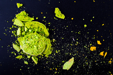 Crushed green macaroon. Tiny particles and black fone.Top view. Flat lay. Macro. Close upの写真素材