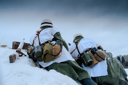 Wehrmacht machine-gun crew. Reconstruction of the winter defensive battles of the Red Army in WWII (1944 year).の写真素材