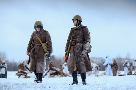 NELIDOVO, MOSCOW REGION, RUSSIA - JANUARY 22, 2017: Reconstruction of the winter defensive battles of the Red Army of the 1st Ukrainian Front in WWII called "Battlefield. Hot snow" (1944 year). Red Army soldiers after the battle.のeditorial素材