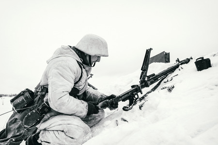NELIDOVO, MOSCOW REGION, RUSSIA - JANUARY 22, 2017: Reconstruction of the winter defensive battles of the Red Army of the 1st Ukrainian Front in WWII called "Battlefield. Hot snow" (1944 year). Wehrmacht machine-gunner. Black and white photo.のeditorial素材