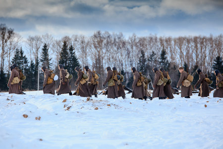 NELIDOVO, MOSCOW REGION, RUSSIA - JANUARY 22, 2017: Reconstruction of the winter defensive battles of the Red Army of the 1st Ukrainian Front in WWII called "Battlefield. Hot snow" (1944 year). Column of the Red Army infantry walks on winter road.のeditorial素材
