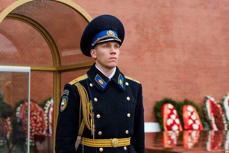 MOSCOW, RUSSIA - MAY 08, 2017: Guard of the Presidential regiment of Russia near Tomb of Unknown soldier and Eternal flame in Alexander garden near Kremlin wall. Rainy view.のeditorial素材