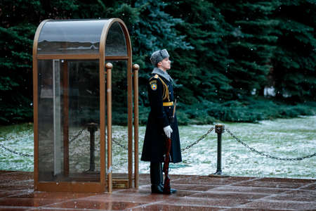 MOSCOW, RUSSIA - DECEMBER 04, 2019: Guard of the Presidential regiment of Russia in winter uniform near Tomb of Unknown soldier and Eternal flame in Alexander garden near Kremlin wallのeditorial素材