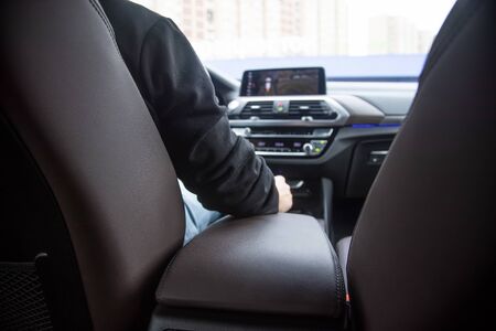 premiium driving. view from the back seat of a modern premium car. the driver sits behind the...