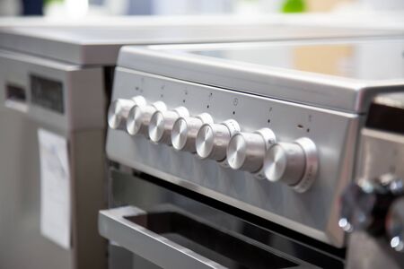 handles of a gas or electric stove, close-up, side view, soft focus.の写真素材