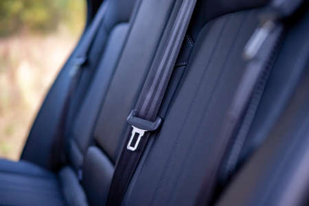 close up of passenger seat belts in the back seat of a modern car safety in car driving concept. no people. empty interiorの写真素材