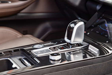 close-up of an automatic transmission knob in a new modern car. side view. empty interior design of...