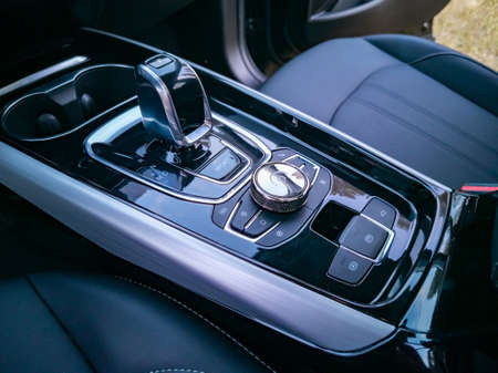 multimedia system control and gearshift in interior of modern premium car, no people. Management of...