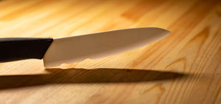 close up old white ceramic knife with a chipped blade. broken substandard knifeの写真素材