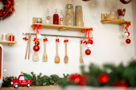 Kitchen wooden countertop with hob and kitchenware decorated for winter holidays: new year christmasの写真素材