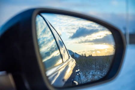 side car rear view nirror with sunsetの写真素材