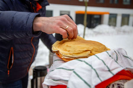russian blili outdoors on celebration maslenitsa.people take pancakes during Shrovetide at Russiaの写真素材
