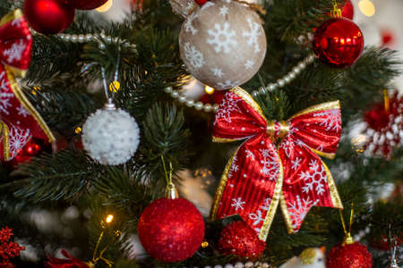 cozy decorated christmas tree with red colored decor in hone interior close upの写真素材