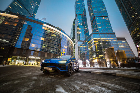Moscow, russia - December 13, 2020: premium suv lamborghini urus stand on parking lots in downtown city nightのeditorial素材
