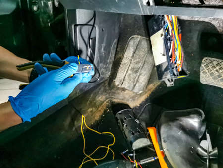 electrician master repairs cables in modern carの写真素材