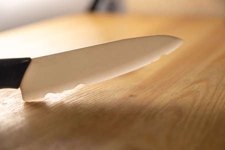 old broken ceramic knife on wooden tableの写真素材