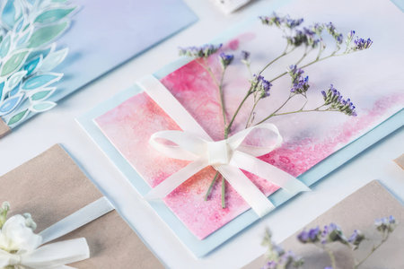 Set of watercolor floral greeting cards with pink and purple flowers and white ribbons