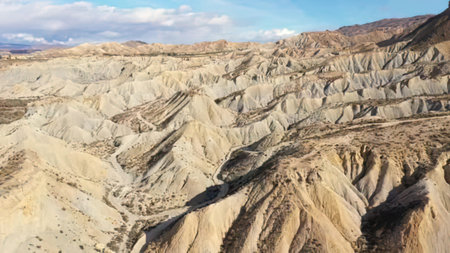 Scenic view of vibrant layered cliffs in a dry desert area with blue sky