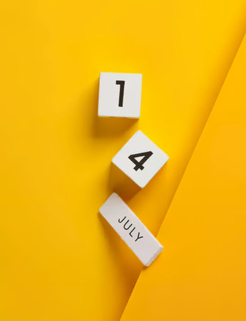 Calendar blocks with the date July 14 on a bright yellow background.