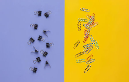 A simple photo showing paper clips and binder clips on colorful backgrounds.