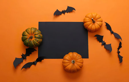 Festive Halloween scene with pumpkins, bats, and a blackboard on orange background