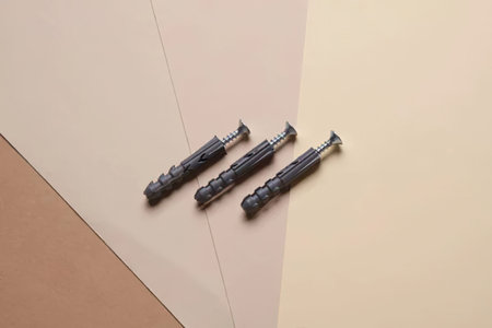 screws on a beige and brown background. construction concept