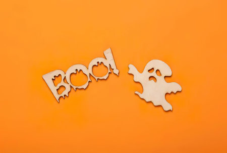 Halloween decoration on orange background, top view, copy space.