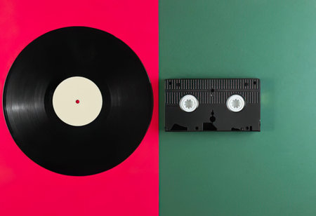 Vinyl record on green and pink background. Retro music concept.