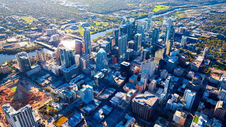 An aerial shot showing a busy city with skyscrapers, streets, and urban landscape.