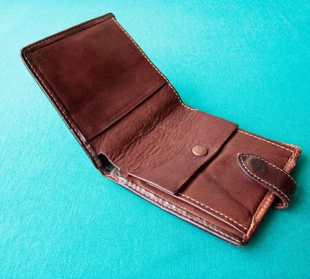 Empty wallet with no money in the background. Bankruptcy is an empty wallet. It is not possible to repay the loan and mortgage. Old and empty brown walletの写真素材