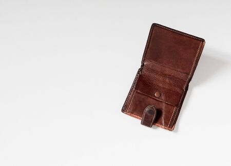 Empty wallet with no money in the background. Bankruptcy is an empty wallet. It is not possible to repay the loan and mortgage. Old and empty brown walletの写真素材