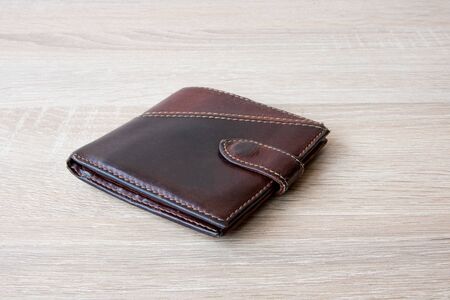 Empty wallet with no money in the background. Bankruptcy is an empty wallet. It is not possible to repay the loan and mortgage. Old and empty brown walletの写真素材