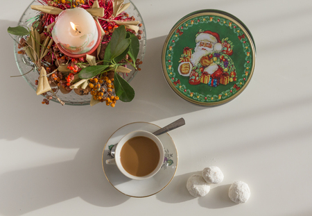 Christmas candle decoration and a glass of coffe の写真素材