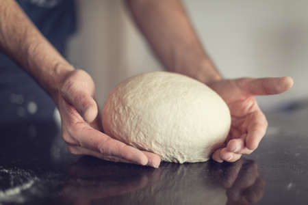Man's hands kneading to make a bread - Close-up