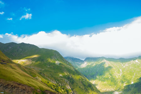 Majestic landscape of summer mountains. View of hills in rays of sunlight. Fagarasan. Amaizing view on the mountains and cloudy sky near Transfagarasan alpine mountain road, Transylvania, Romaniaの写真素材